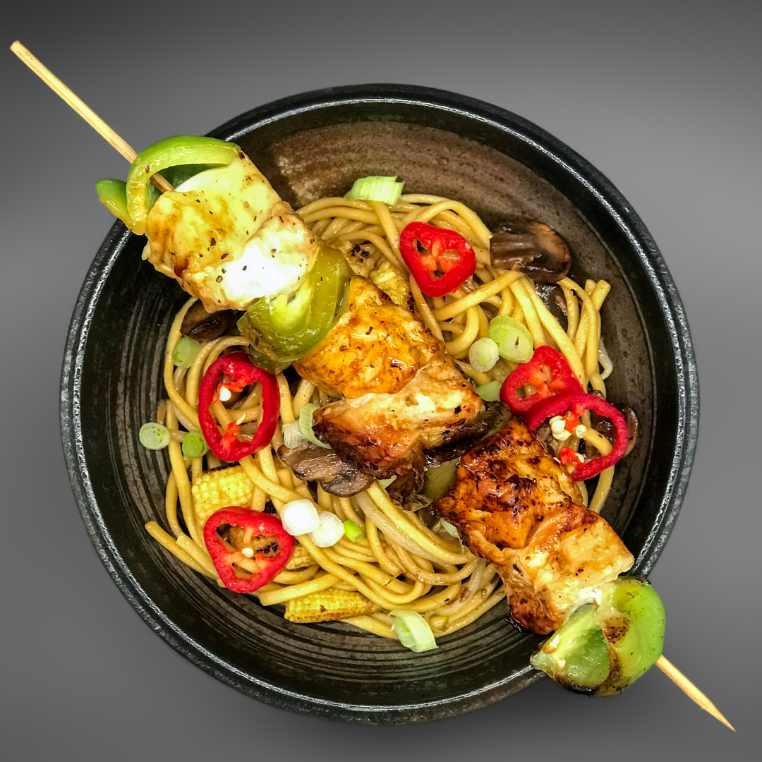 Yakitori skewer of Oumi cheese, chicken and green pepper over noodles with red chilli, mushrooms and spring onion