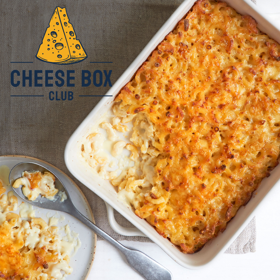 Baked macaroni cheese with a golden top in a white dish and a serving on a plate, with the Cheese Box Club logo