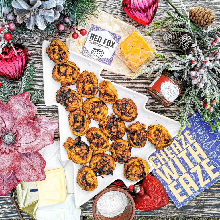 Cheese and chutney pastry whirls on a Christmas tree platter, with a pack of Red Fox cheese and a jar of chutney