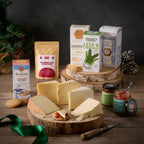 Angel of the North Box: five cheese wedges on a log board with crackers, Maclean's biscuits, Northumberland Strong Blend coffee and two chutneys
