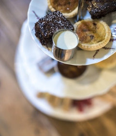 Brownies and small tarts on an afternoon tea stand at the Cheese Loft Café