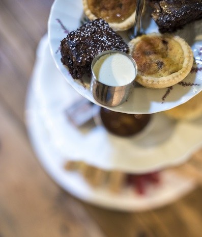 Brownies and small tarts on an afternoon tea stand at the Cheese Loft Café