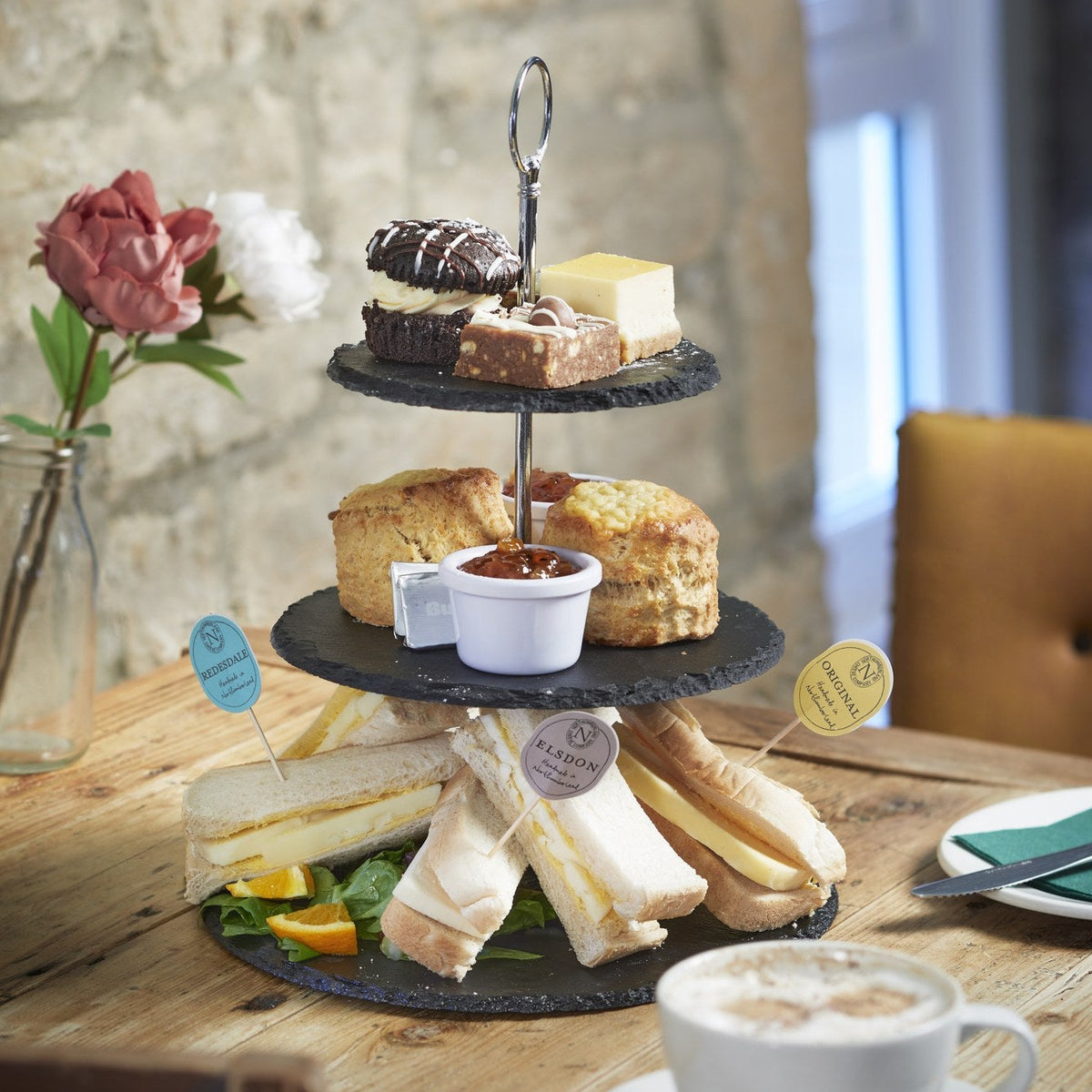 Cheese Lovers' Afternoon Tea on a slate stand: sandwiches flagged Redesdale, Elsdon and Original, cheese scones and cakes