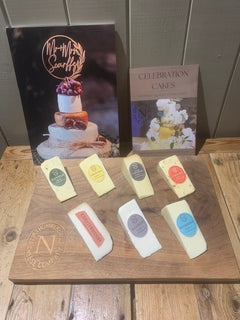 Cheese Wedding Cake Sample Pack: Nettle, Original, Oak Smoked, Chilli, Chesterwood, Elsdon and Redesdale wedges on a wooden board