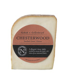 Chesterwood Smoked Goats Cheese 150g wedge with a russet smoked rind in its terracotta Northumberland Cheese Company label
