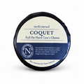 Black-waxed Coquet truckle with its cream label for a mature white Cheddar infused with garlic and herbs