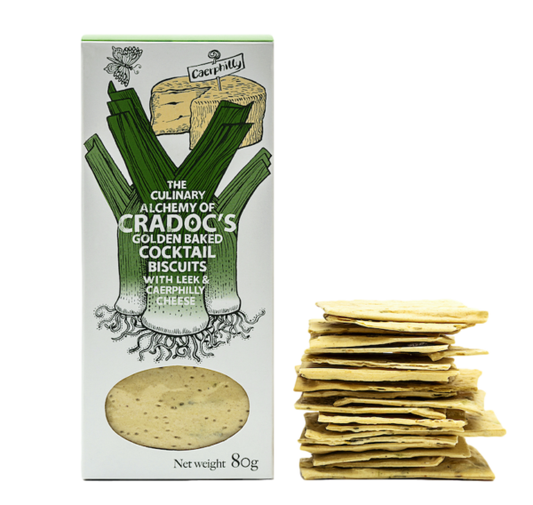 Cradoc's Leek & Caerphilly Crackers 80g box illustrated with leeks and Caerphilly, beside a stack of square crackers