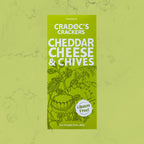 Green 80g box of Cradoc's Gluten Free Cheddar & Chives Crackers on a matching green marble background