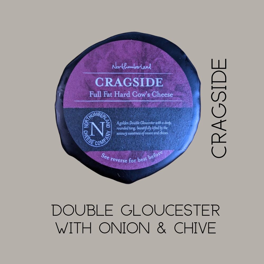 Cragside truckle on a grey background, captioned Double Gloucester with onion and chive