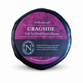 Black-waxed Cragside truckle with its purple label for a golden Double Gloucester with onion and chives