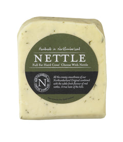 Nettle Cheese wedge flecked with green nettles in its dark green Northumberland Cheese Company label