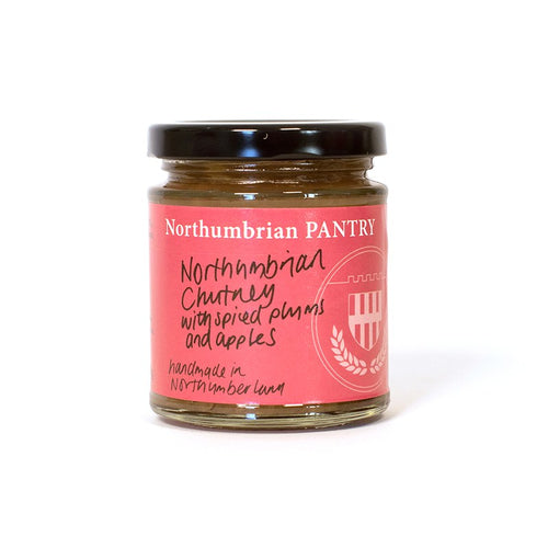 210g jar of Northumbrian Pantry Spiced Plum & Apple Chutney with a pink hand-lettered label and black lid