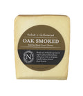 Oak Smoked Cheese wedge with a bronzed smoked rind in its olive brown Northumberland Cheese Company label