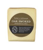 Oak Smoked Cheese wedge with a bronzed smoked rind in its olive brown Northumberland Cheese Company label