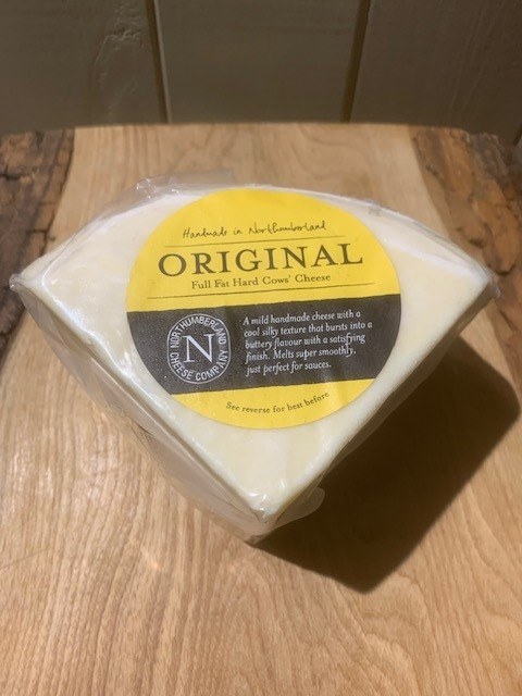 Vacuum-packed wedge of Original Cheese with its yellow label, standing on a rustic wooden board